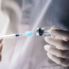 doctor leading a needle from a vial