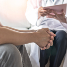 hands folded at a patient physician consultation