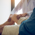 doctor examining a patient's knee