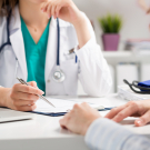 physician looking at patient chart