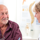 elderly man talking with doctor